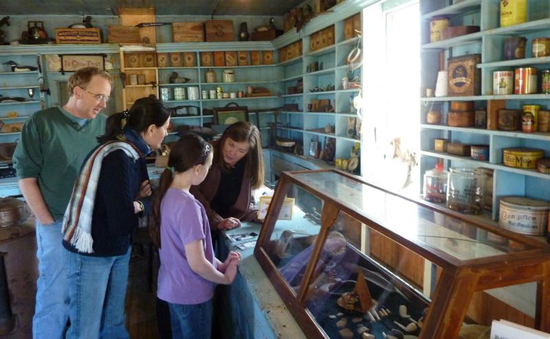 A tour guide describes historic items to a family inside the Bucktown, Maryland, store.